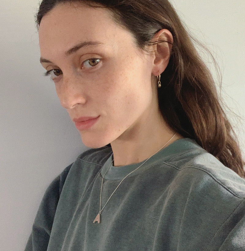 Woman wearing a green shirt against a plain background