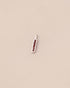 Small pendant with a textured design on a beige background