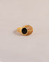 A gold ring featuring a scarab design with onyx and yellow opal inlays, displayed against a neutral background.