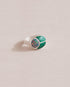 A silver ring featuring a central opal stone flanked by malachite stones on either side, set against a neutral background.
