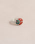 A silver ring featuring a scarab design with starry opal and red jasper inlays, displayed against a neutral background.