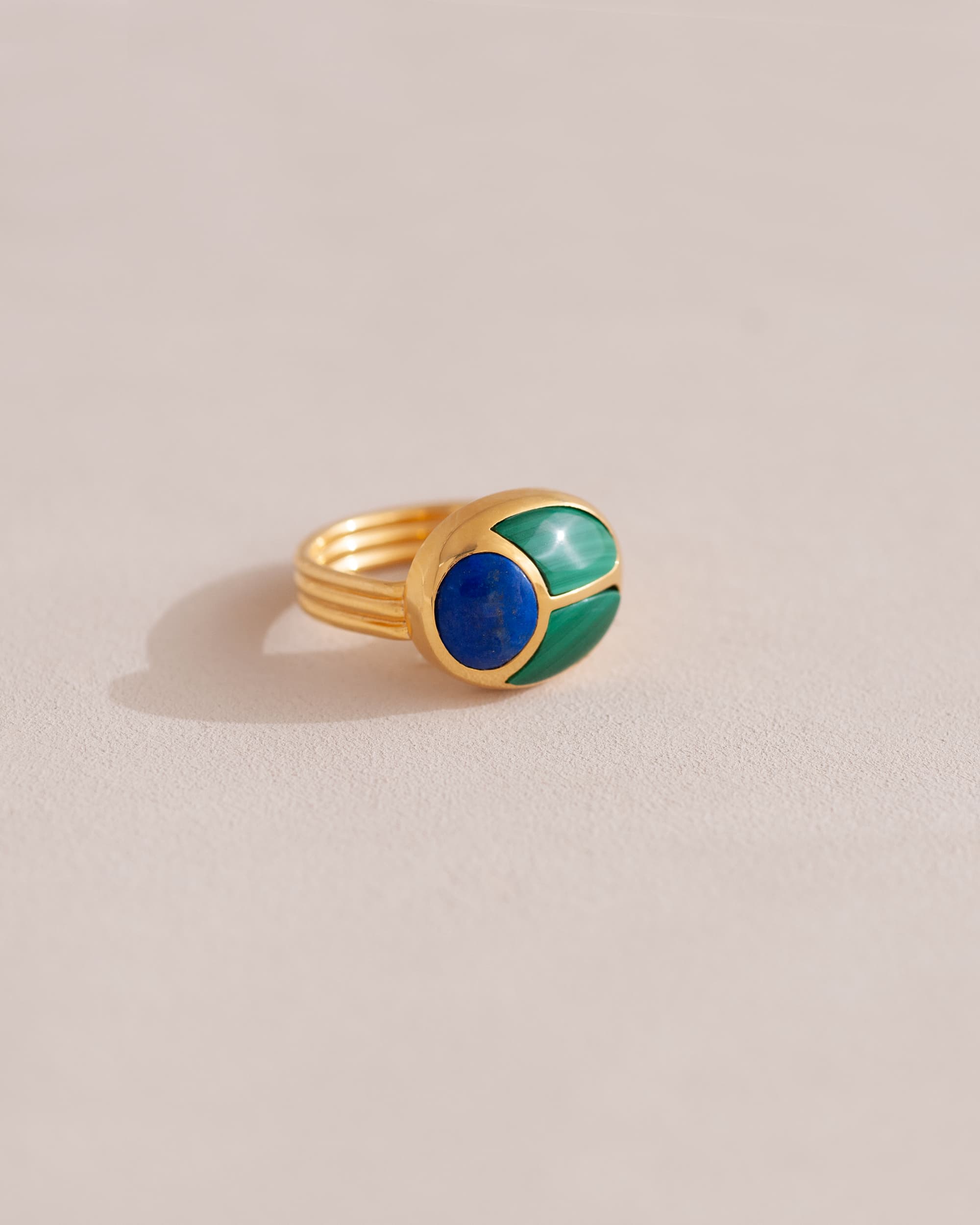 A 14K yellow gold ring with a blue and green lapis lazuli and malachite stone in the center.