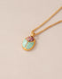 A gold vermeil necklace featuring a scarab amulet with Cantera Opal and Mint Variscite inlays, displayed on a plain background.