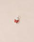 A small silver charm featuring a red jasper and opal scarab design.