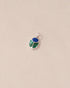 A silver-colored charm with a round lapis lazuli and a teardrop-shaped malachite, attached to a small silver ring.