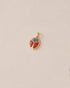A small gold charm featuring a red jasper and opal scarab design.