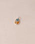 A silver charm featuring a starry opal and mookaite design, shaped like a scarab amulet, displayed against a neutral background.