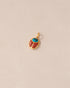 A 14K yellow gold charm featuring a turquoise and red jasper scarab design.