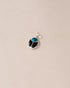 A small turquoise and onyx scarab charm in silver, displayed against a neutral background.