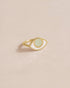 A 14K yellow gold ring with an opal in the shape of an eye set on a neutral background.