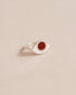 A silver ring with a snake skin jasper stone set in the center, placed on a light background.