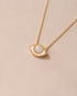 gold eye pendant inlaid with mother of pearl with gold chain