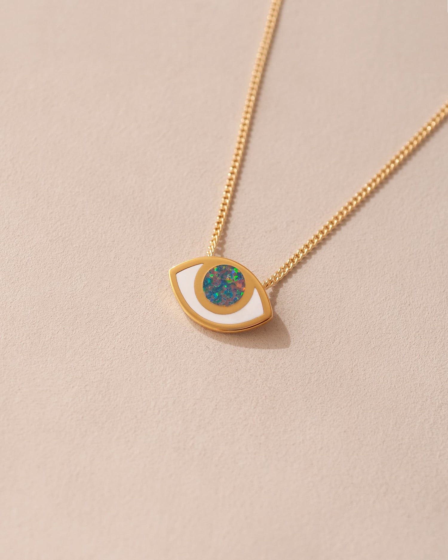 gold eye pendant inlaid with opal with gold chain