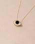 A goldstone eye talisman pendant necklace in 14K yellow gold, displayed against a light background.