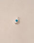 Small white container with blue substance on a beige background