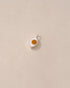 A small silver charm with a mookaite stone in the shape of an eye, displayed against a neutral background.