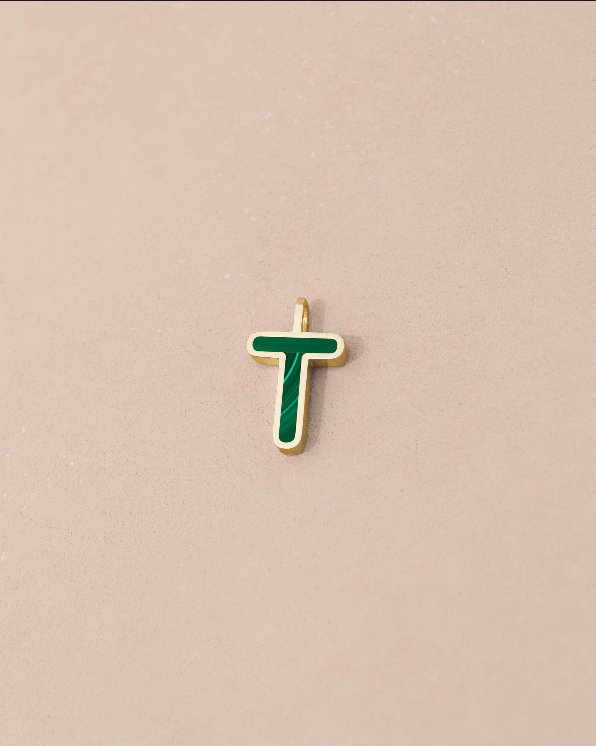 Gold pendant with green enamel letter &