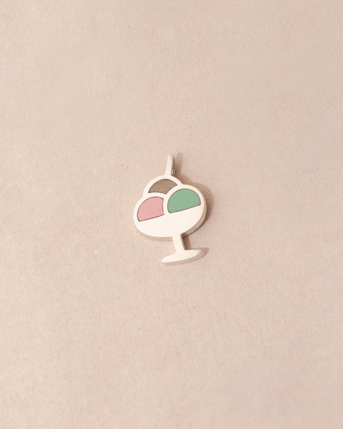Decorative pendant with a pink and green design on a beige background