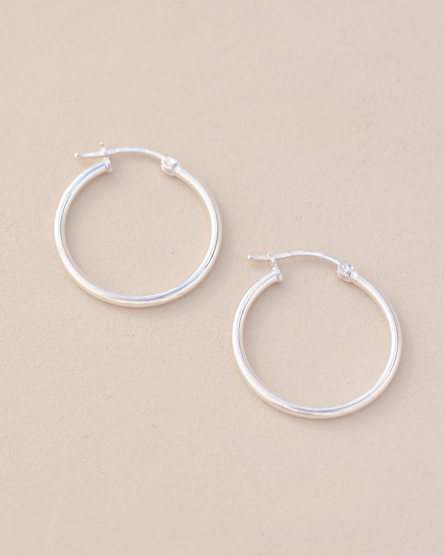 silver hoops on neutral background