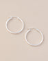 silver hoops on neutral background