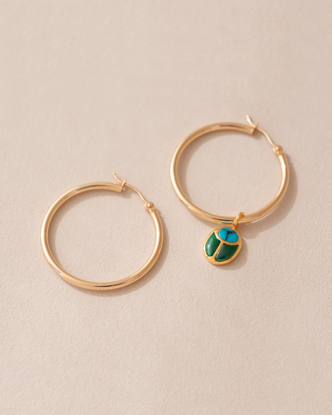 gold hoops with gold scarab charm