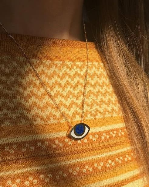 An eye shaped pendant on a model