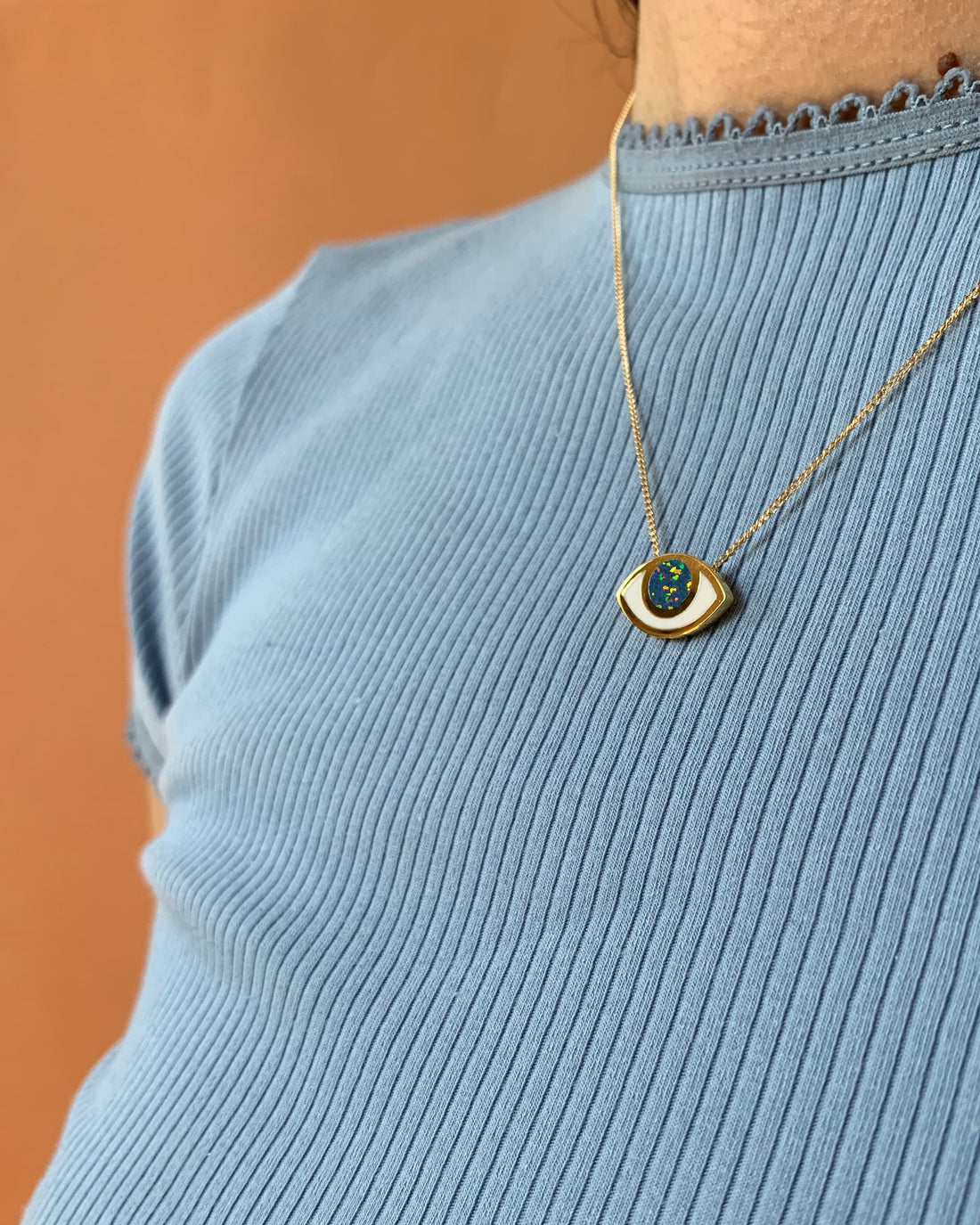 An eye shaped pendant on a model