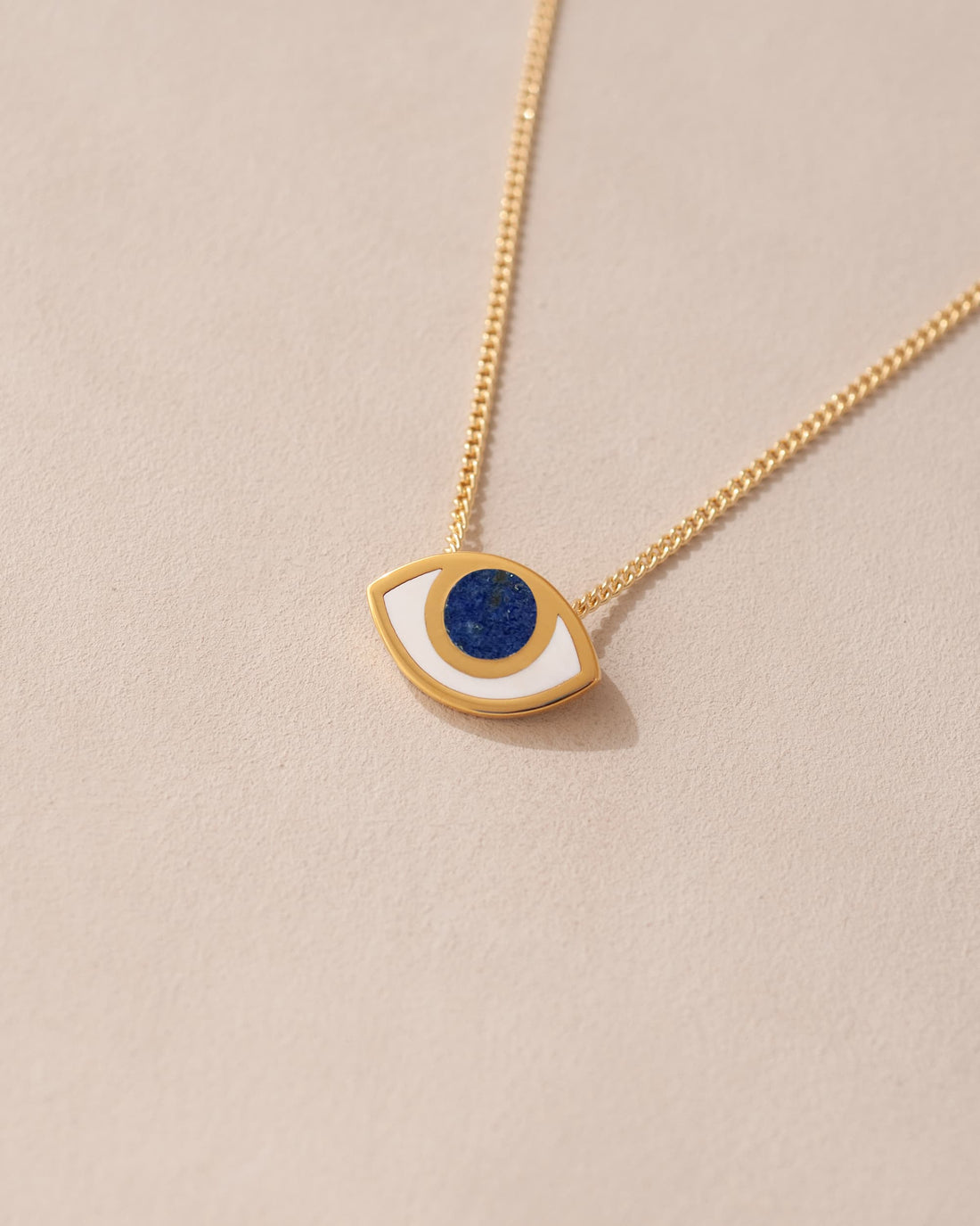 gold eye pendant inlaid with lapis lazuli with gold chain