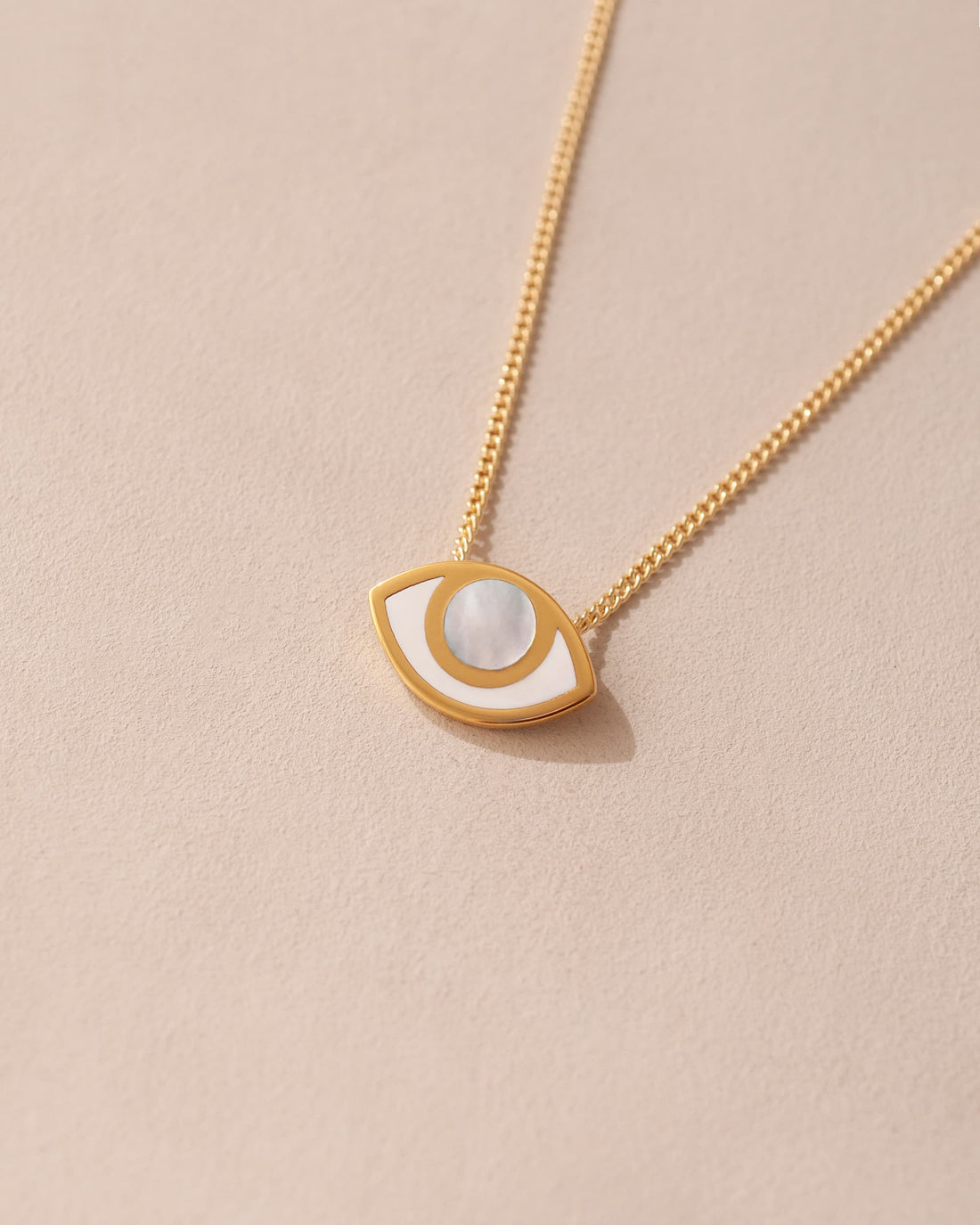 gold eye pendant inlaid with mother of pearl with gold chain
