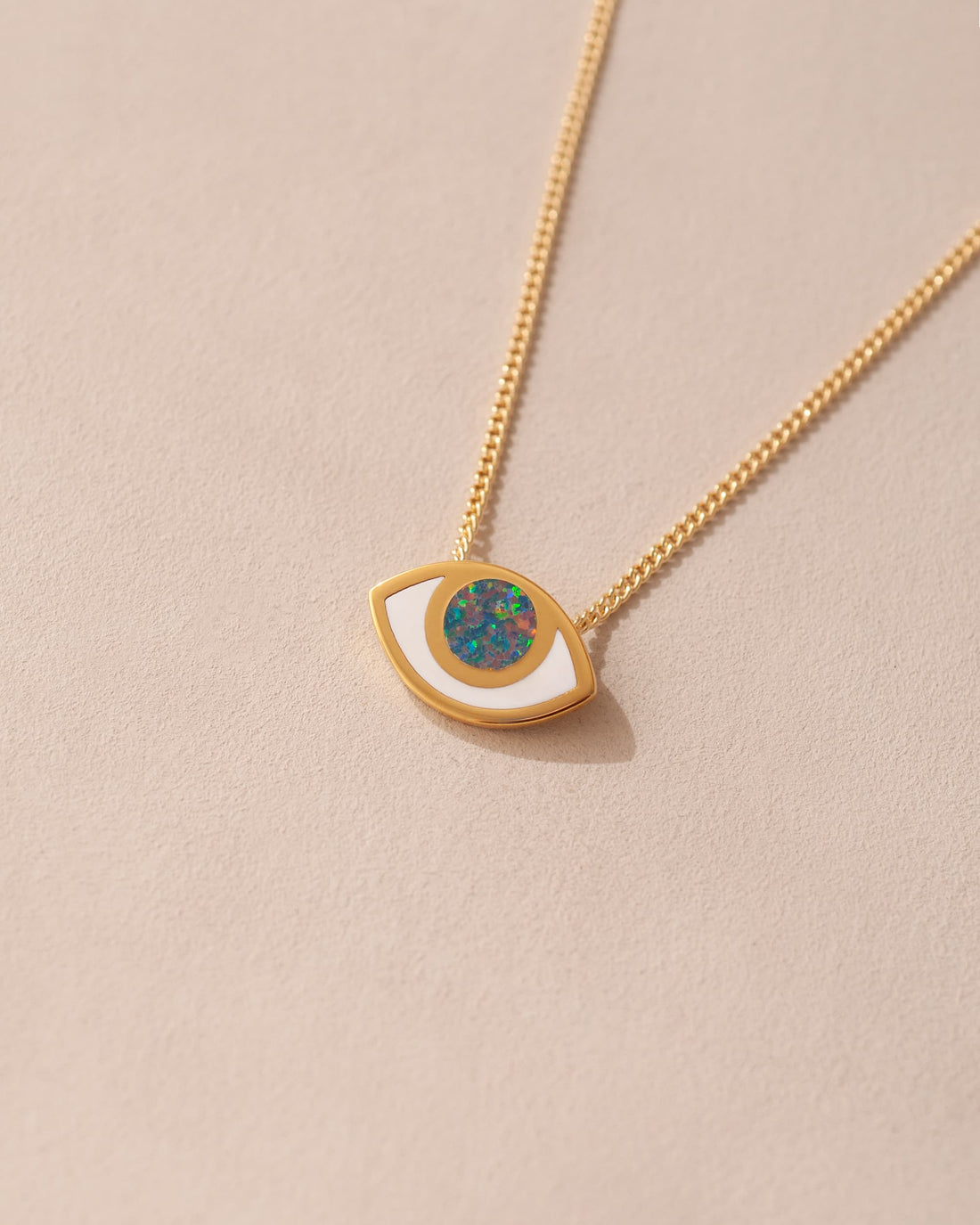 gold eye pendant inlaid with opal with gold chain