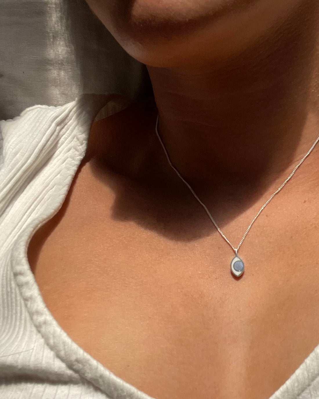 An eye shaped charm on a model