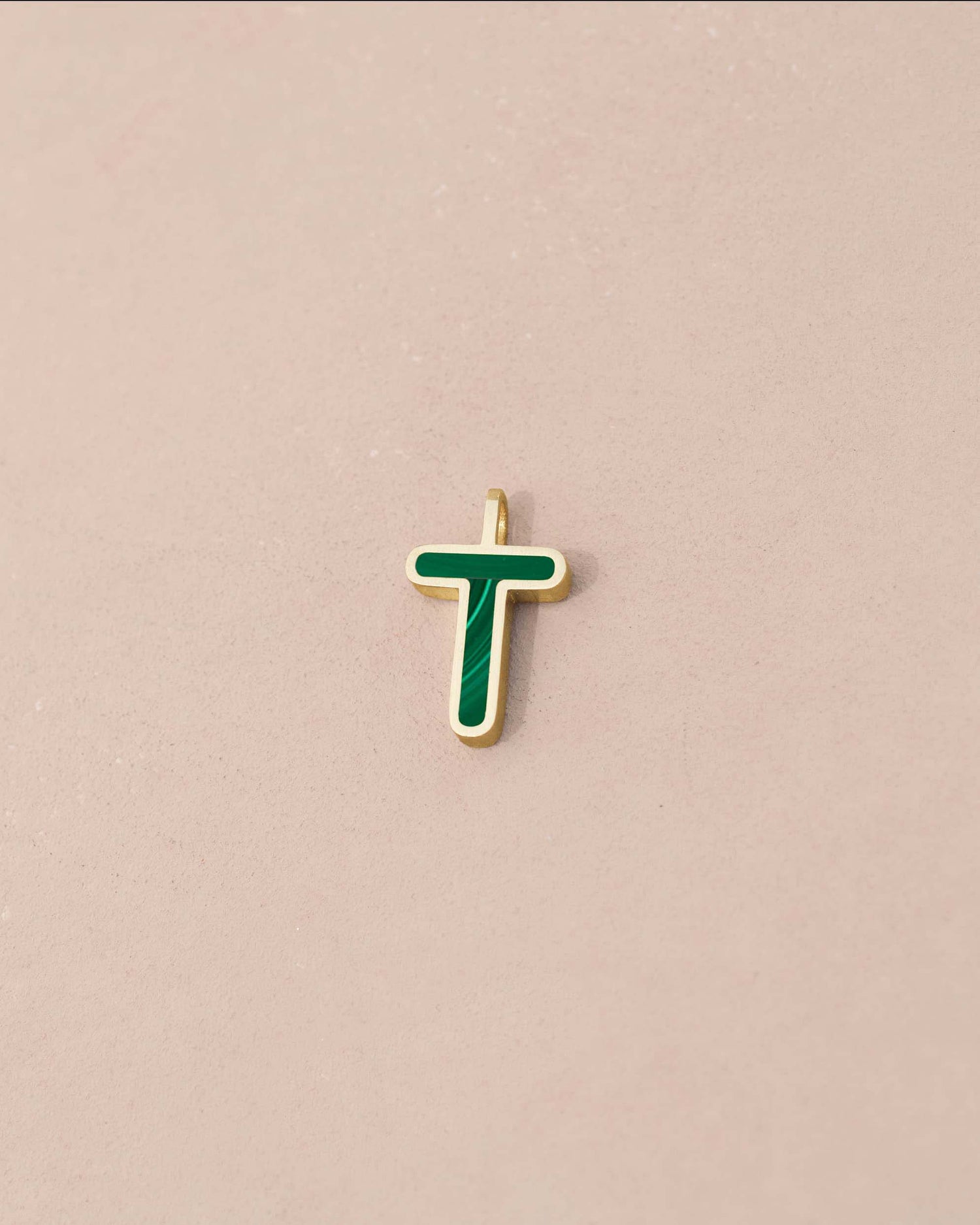 Gold pendant with green enamel letter &