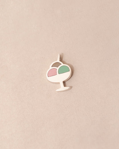 Decorative pendant with a pink and green design on a beige background