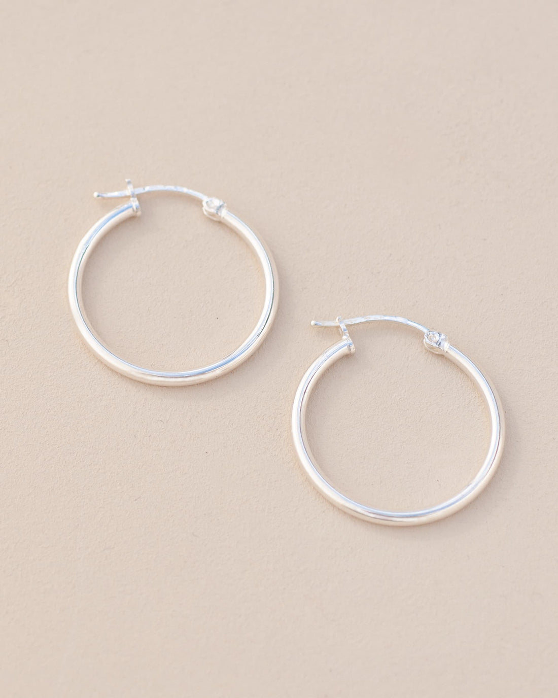 silver hoops on neutral background